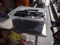 Full view of tote on table showing quantity of remote controls inside