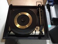 Turntable with lid open showing platter, tonearm, Dual logo