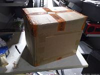 Sealed shipping carton with orange security tape