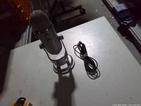 Front view of Blue Yeti microphone on stand with USB cable