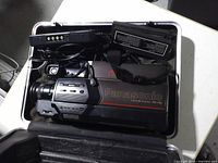 Camcorder, charger, batteries and case interior