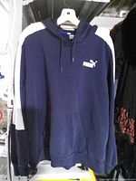 Front view of navy Puma hoodie showing logo, pocket and drawstrings