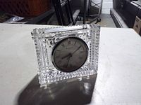 Front view of rectangular cut crystal clock showing dial