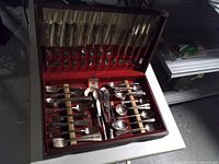 Closed chest opened to show full flatware set