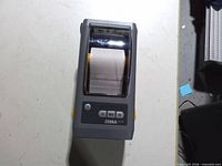 Front top view showing control panel, logo and loaded label roll