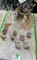 Overview of glassware, pitcher, plastic tumblers, and some utensils