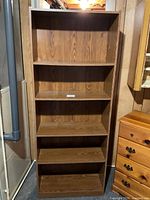 Front view of laminate bookcase showing shelves and condition