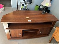 Front view of cherry media console with lamp on top