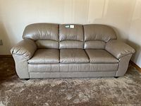 Front view of taupe leather 3-seat sofa