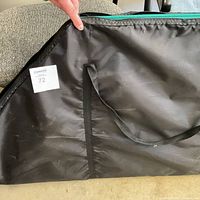 Black nylon carrying case with handle and MaxSold label