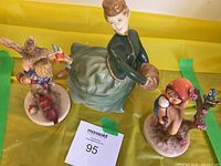 All three porcelain figurines grouped together for size and style comparison