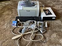 Overall lot showing HP printer, keyboard, Panasonic phone, Nixplay box and cables