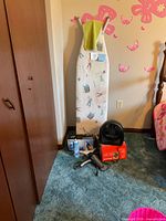Ironing board with printed cover, fan, iron box, hair dryer, spray starch
