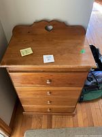 Top view and front of 4-drawer wooden cabinet with heart cutout back board