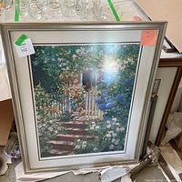 Large framed garden print with dog in floral entryway