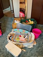 Group shot showing cradle, bassinet, mirror, plush toys, organizer and accessories