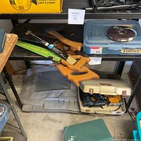 Shelf with hand saws, bow saw blades, jigsaw in beige case