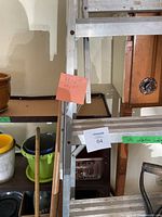 Ladder, shelving, broom, plant pots in view