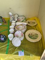 Lot overview of Royal Albert dinnerware, showing pitcher, teacups, padded cases and stacked dinner plates