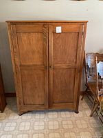 Front view showing two paneled doors and overall finish