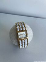 Front view of watch showing rectangular dial and bracelet