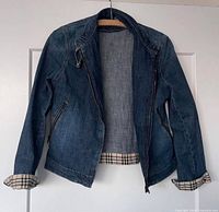 Front view of Burberry denim jacket open showing plaid lining cuffs and collar belt tab