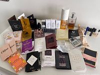 Overall view of full bottle, travel sprays, carded samples and loose vials