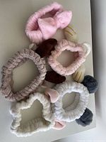 Group of six plush skincare headbands showing colours and designs