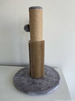 Full view of scratching post on grey base