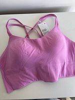 Front view ribbed bright pink Lululemon sports bra with tag