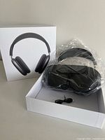 Headphones in Smart Case, charging cable and box contents visible