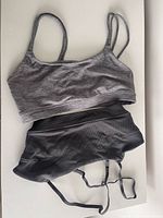 Grey GapFit sports bra and black Abercrombie sports bra displayed flat