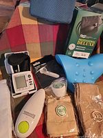 Group shot showing BP monitor, stethoscope box, cervical pillow, oximeter, stockings, lancing device, Braun item