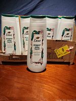 Front view showing Dove Peppermint Bark bottle with carton holding additional bottles