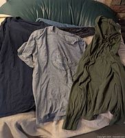Three shirts laid out - navy short-sleeve, grey Old Navy, olive Gap hooded long-sleeve