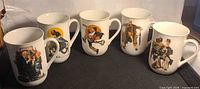 Group shot of five Norman Rockwell mugs showing different illustrations
