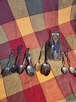 Group of 9 collectible spoons including boxed Disney Treasures spoon and 8 loose spoons