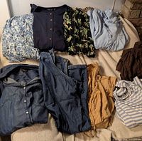 Assorted garments laid out on bed