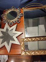 All four mirrors displayed on table