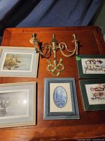 Group view of sconce and five framed prints