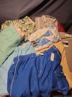 Assorted shorts, swim trunks, shirts and pants laid out