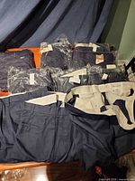 Multiple pairs folded and packaged on table, shows overall quantity