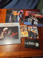 Overview showing all media items: three LaserDiscs, Blue Collar DVD, VHS movies and loose VHS cassette