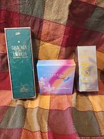Three sealed perfume boxes side by side