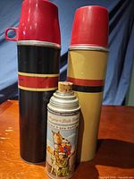 Front view of all three thermoses standing upright