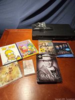 Sony DVD player with remote and all media items arranged on table