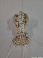 Full front view of resin angel statue on base