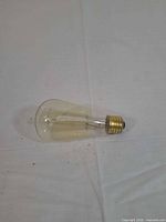 single amber ST64 Edison bulb side view