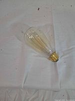 Single ST64 amber Edison bulb full view