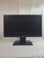 Front view of Acer V206HQL monitor on stand